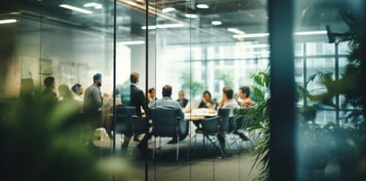 Business leaders collaborating around a table with an EOS Accountability Chart displayed, symbolizing clarity and accountability in SMBs. | vcfo