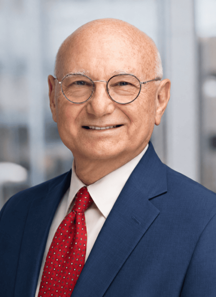 Mike Wilfley smiling in a blue suit and red tie, professional headshot for vcfo.