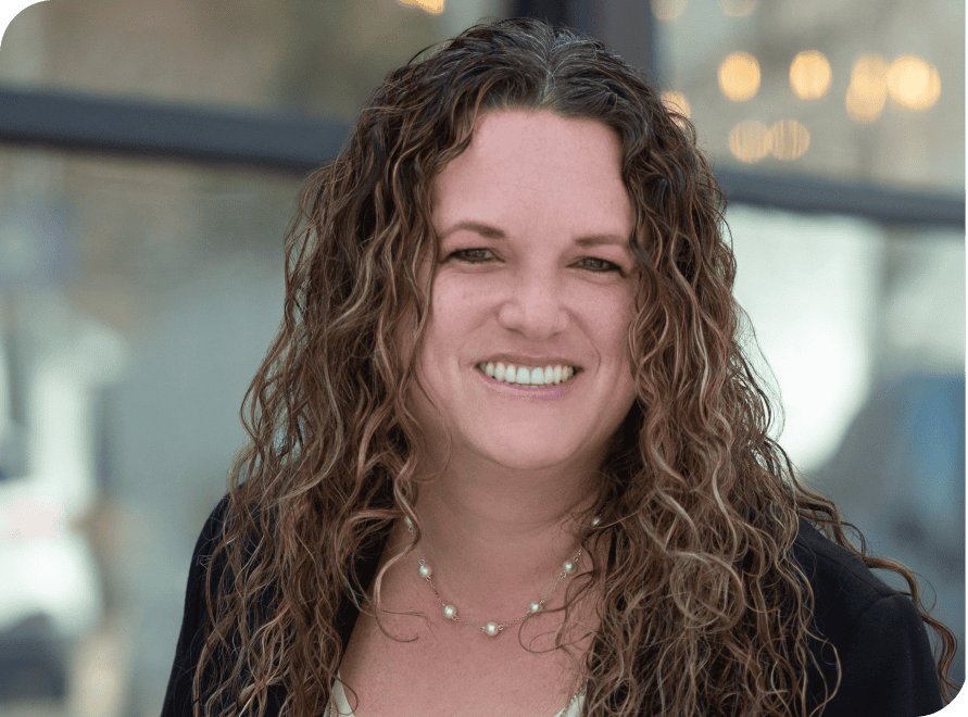 Financial consulting professional Stephanie Herrera smiling outdoors, showcasing expertise in CFO se.