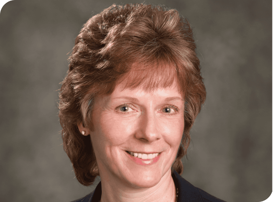 Portrait of Lori Sanford, vcfo executive, smiling in professional attire.