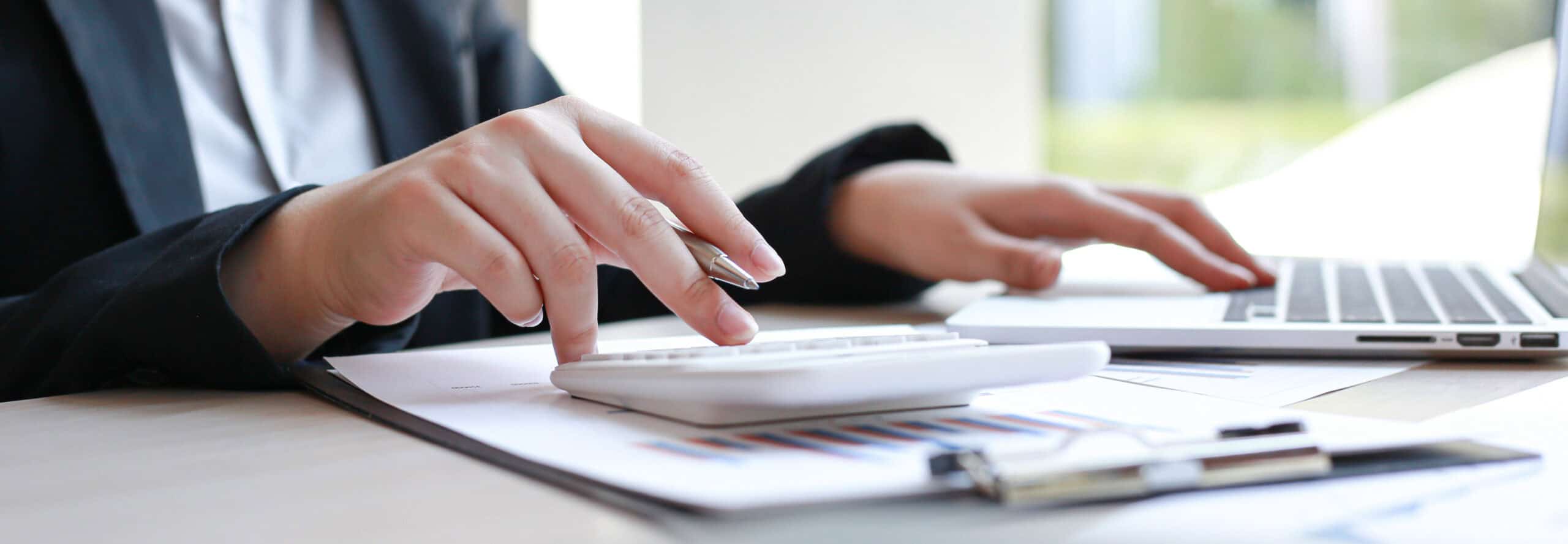 Business professional analyzing financial documents for valuation purposes.