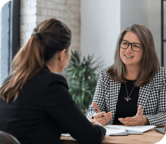 Two women having a professional discussion in an office setting.