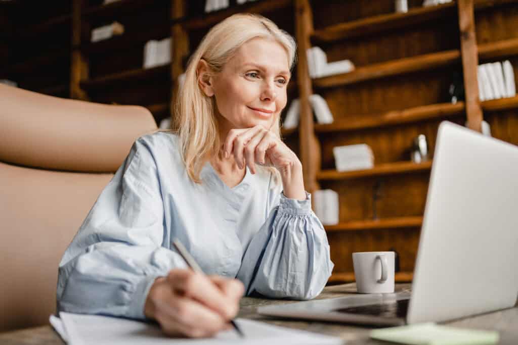 Businesswoman working on financial planning at her desk.