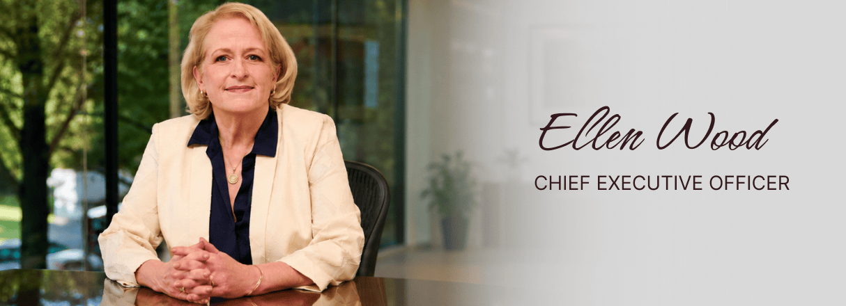 Ellen Wood, CEO, sitting at a desk in a modern office setting.