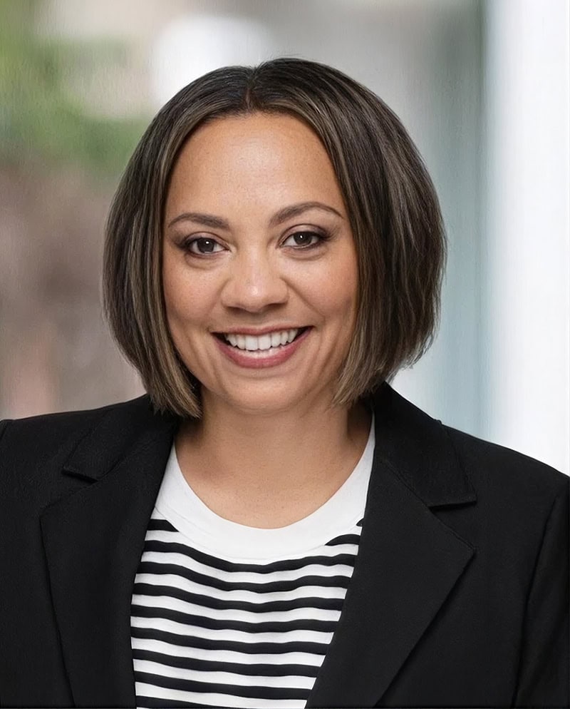 Businesswoman smiling in professional attire for corporate image.