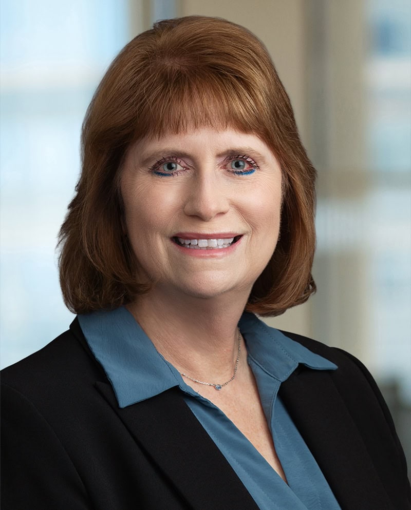 Connie Harrison smiling in professional attire for business profile.