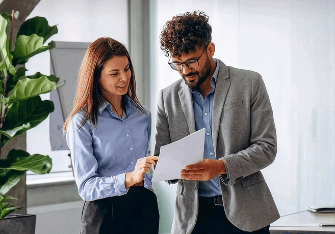 Business colleagues reviewing documents in an office setting.