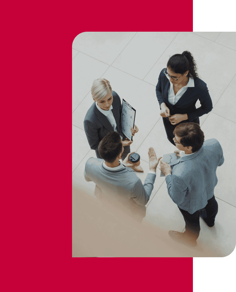 Business professionals having a discussion in a modern office space.