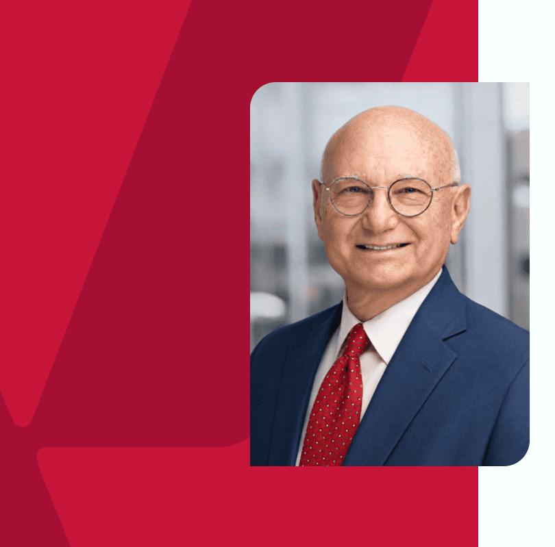 Senior businessman in a suit smiling, professional headshot for Houston business context.