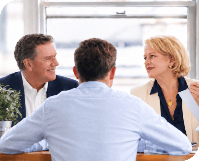 Business professionals engaged in a discussion during a meeting at the office.