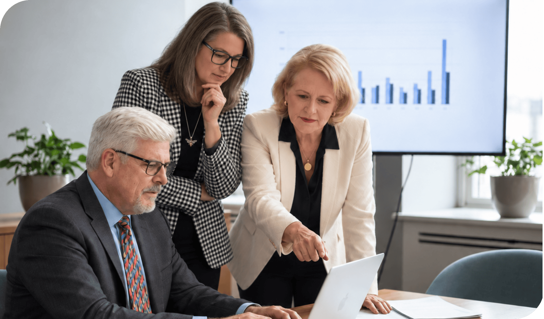 Business team analyzing data and discussing strategies in a modern office.