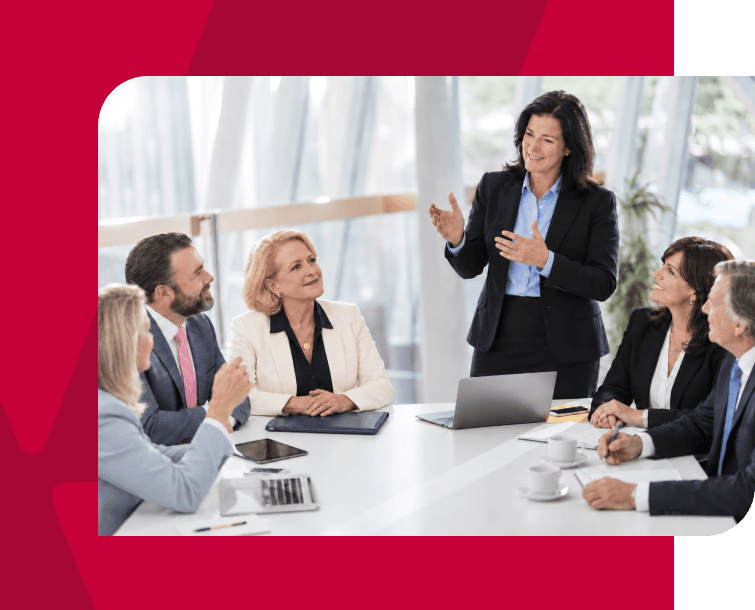 Businesswoman presenting to a diverse group in a modern conference room.