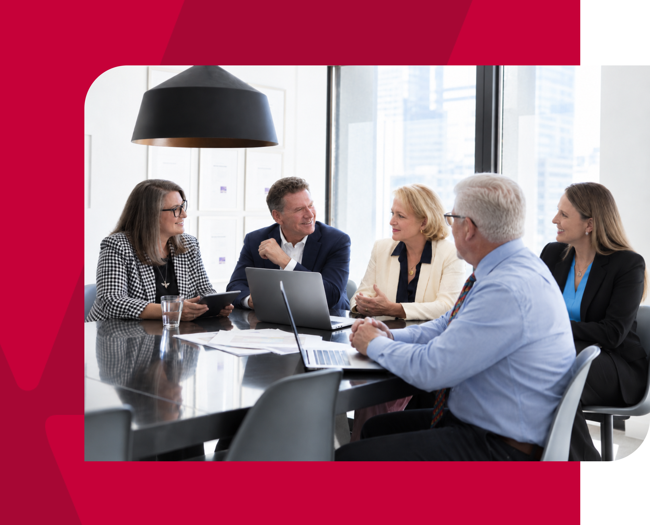 Business team in a meeting discussing strategies in a modern office setting.