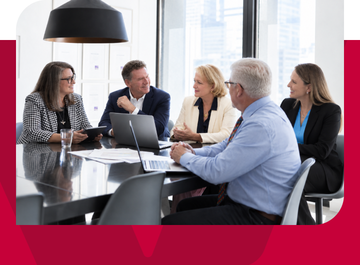 Business meeting with diverse professionals discussing strategies in a modern office.