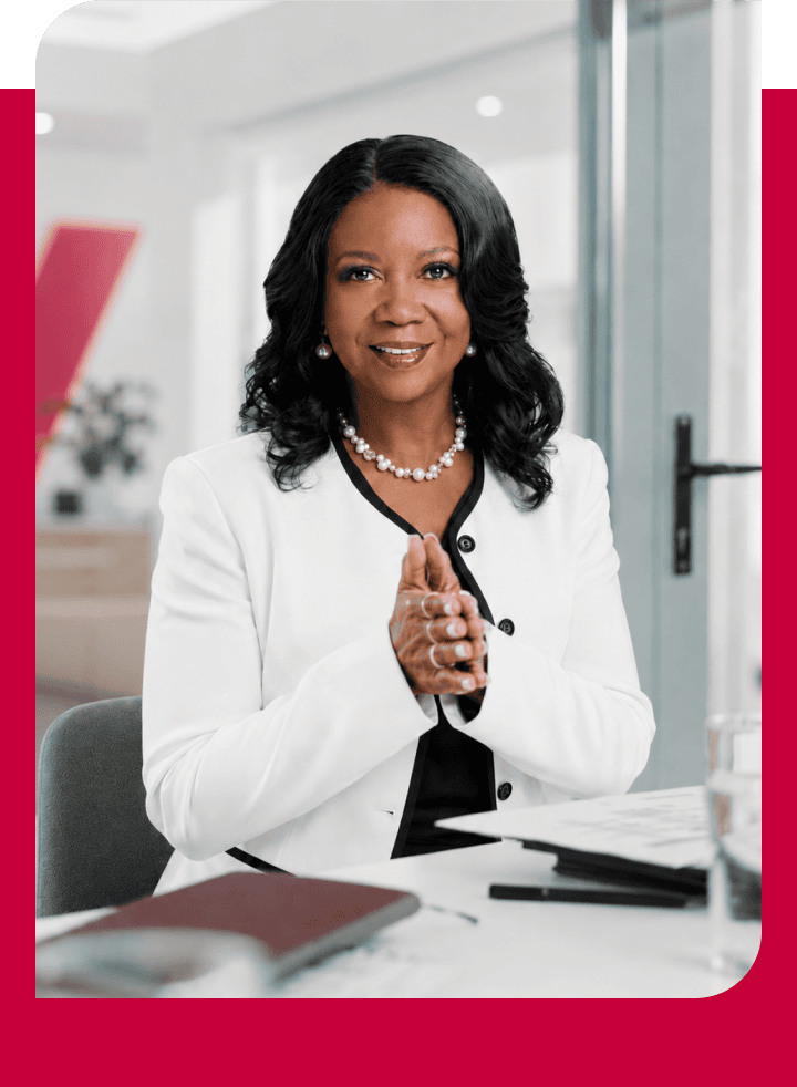 Professional woman in business attire smiling at the camera.