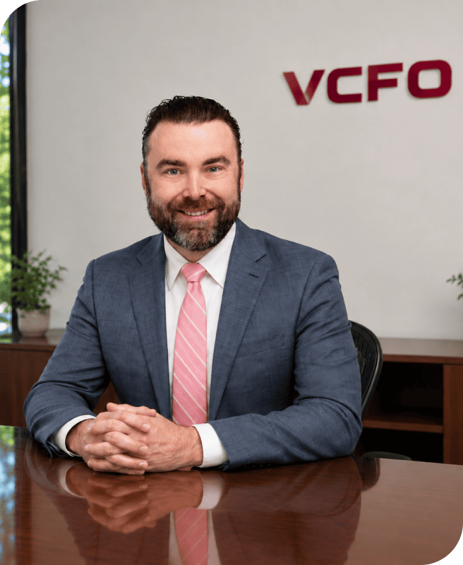Professional businessman in a suit at VCFO office for news article.