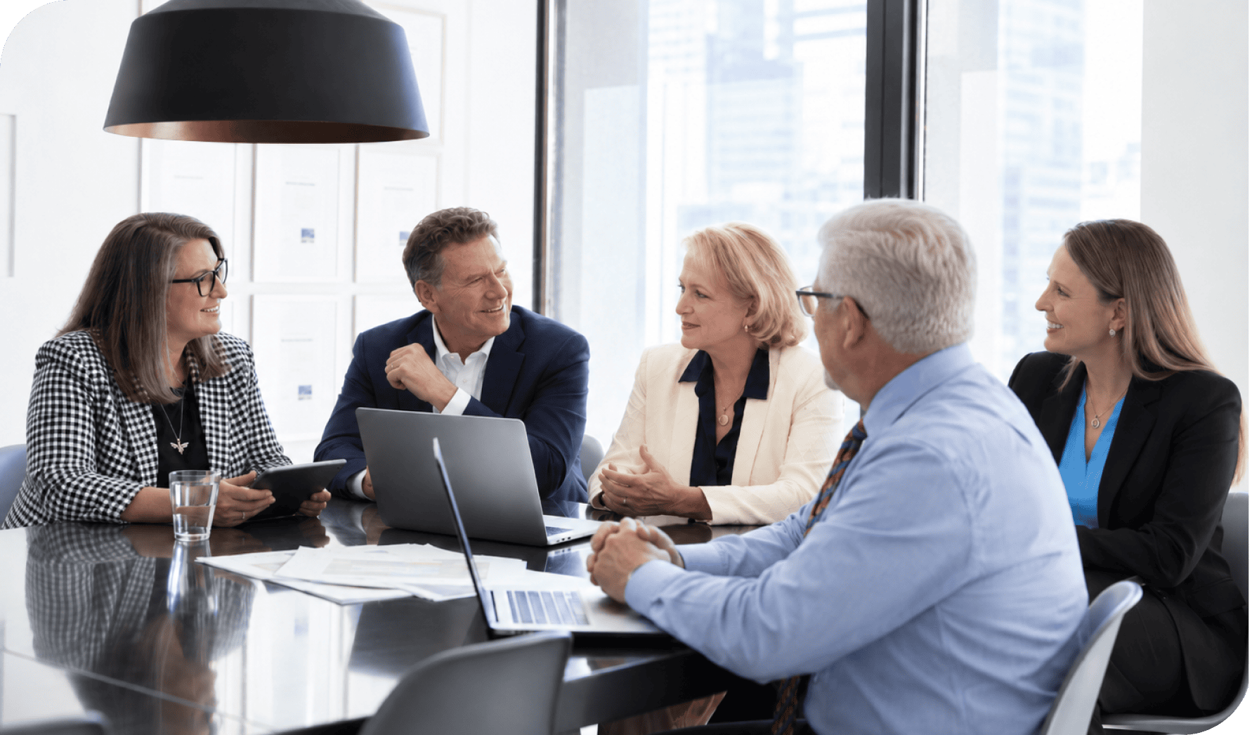 Business team in a meeting discussing strategies at a modern office.