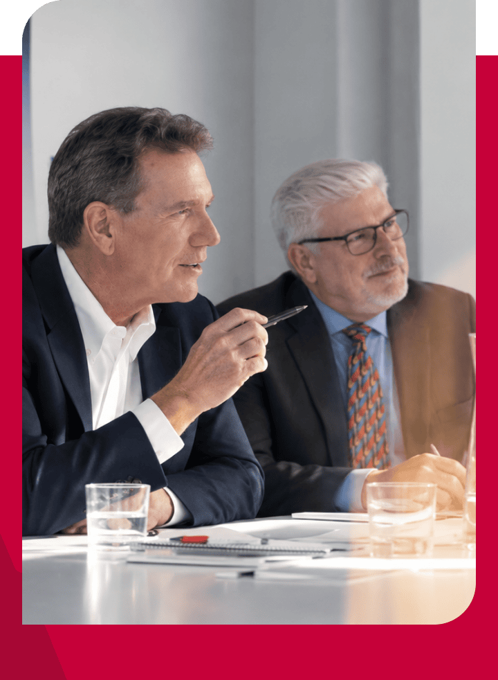 Business professionals discussing during a meeting at a conference table.