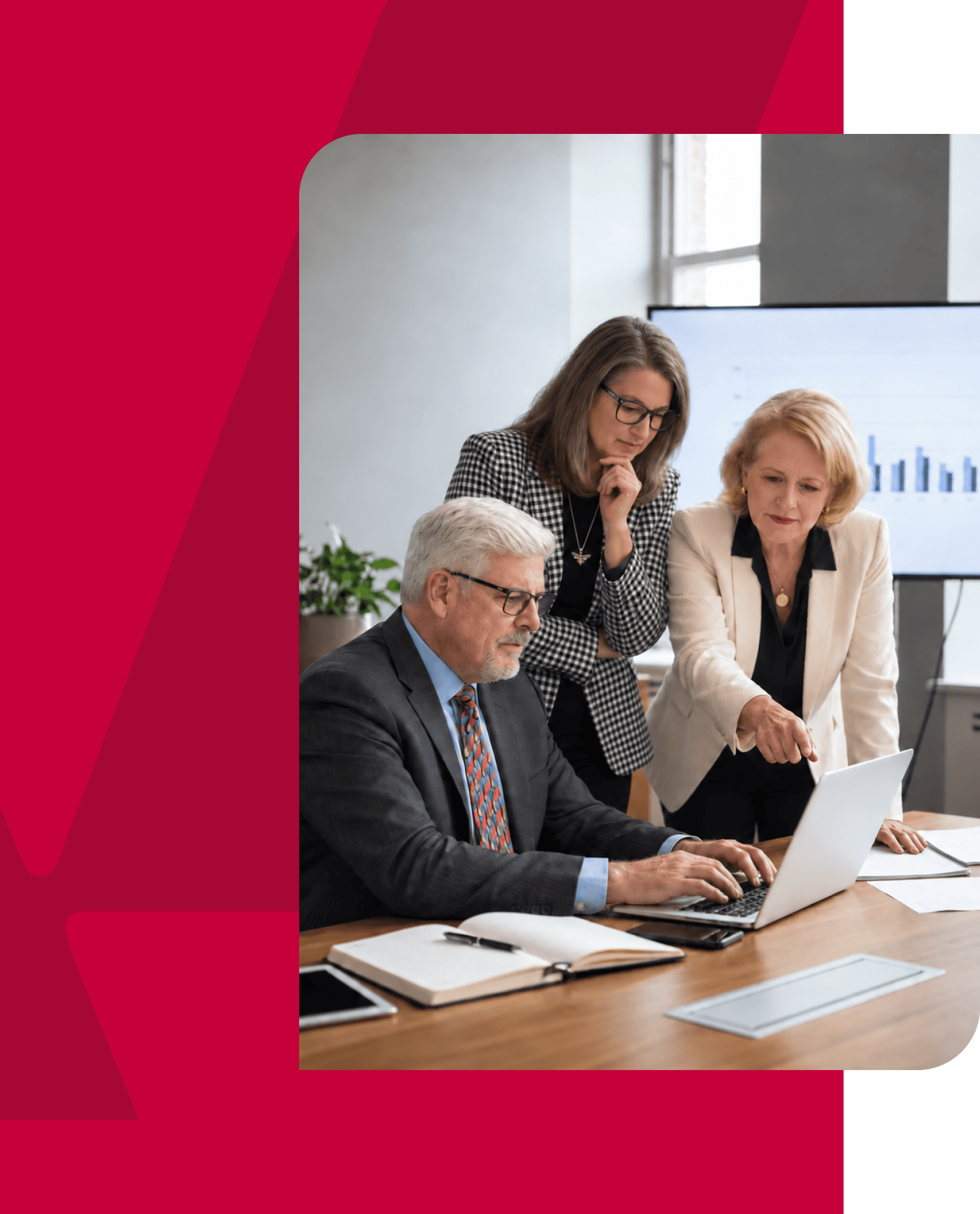 Business team analyzing data on a laptop during a meeting.