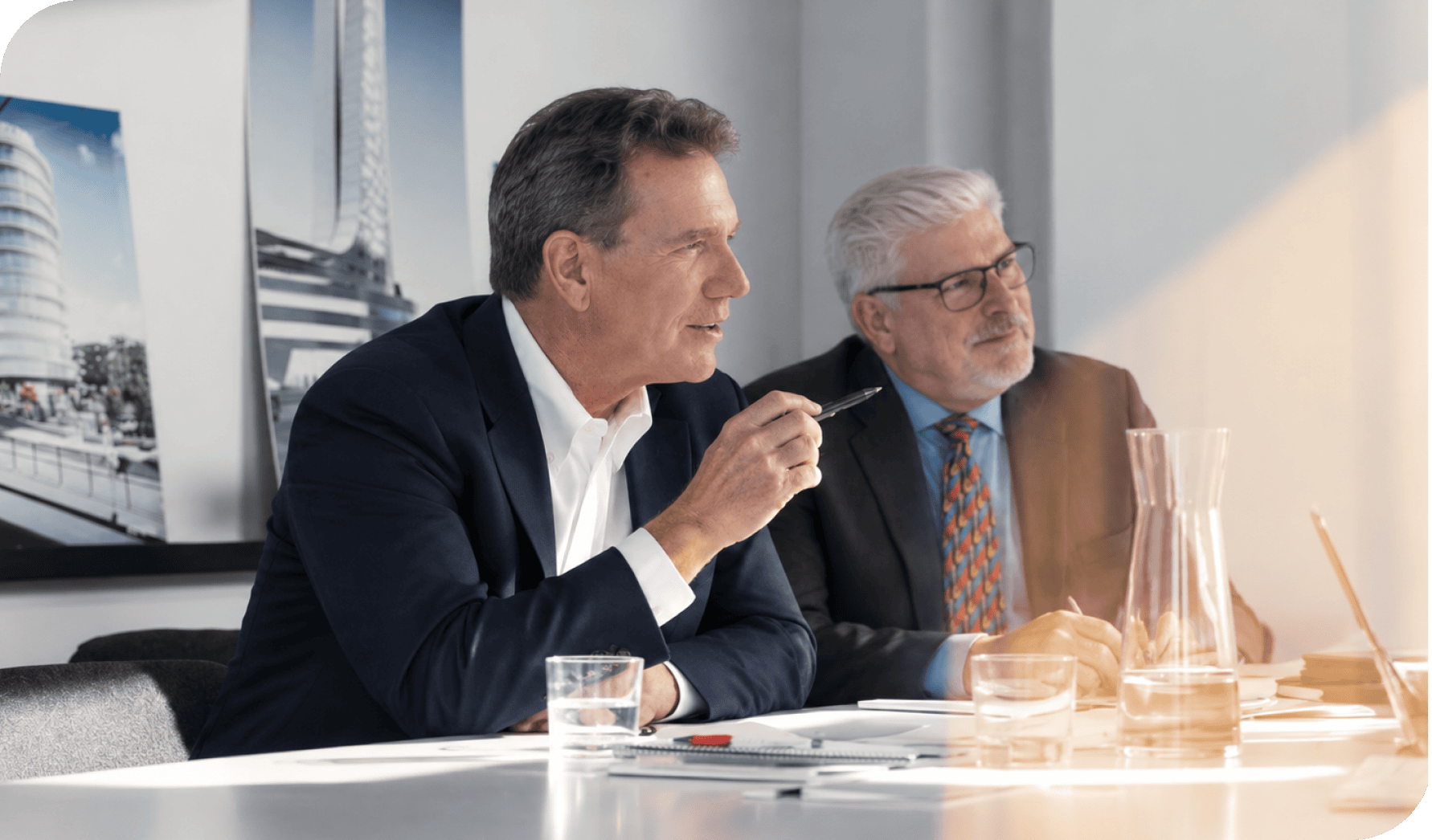 Business professionals discussing strategy at a modern conference table.