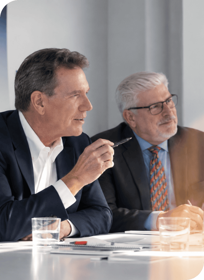 Business professionals discussing strategy at a corporate meeting.