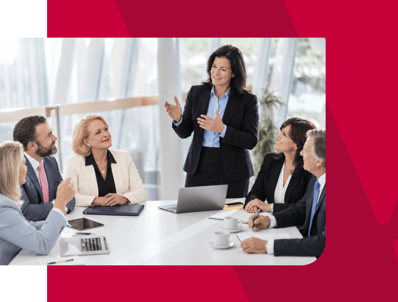 Businesswoman leading a meeting with diverse professionals in a modern office.