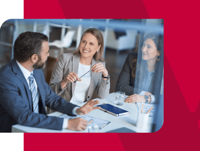 Business professionals having a discussion in a modern office setting.