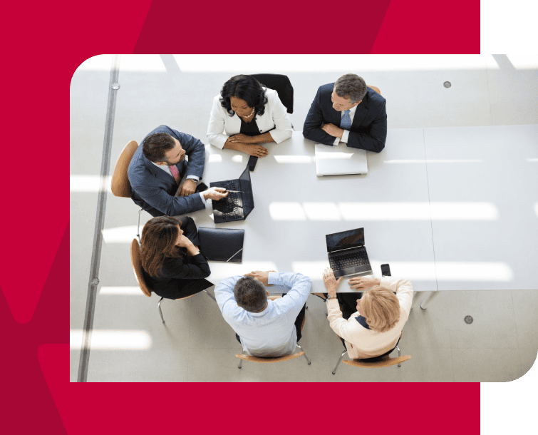 Business team in a meeting discussing strategies at a conference table.