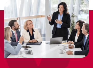Businesswoman leading a meeting with diverse professionals in a modern office.